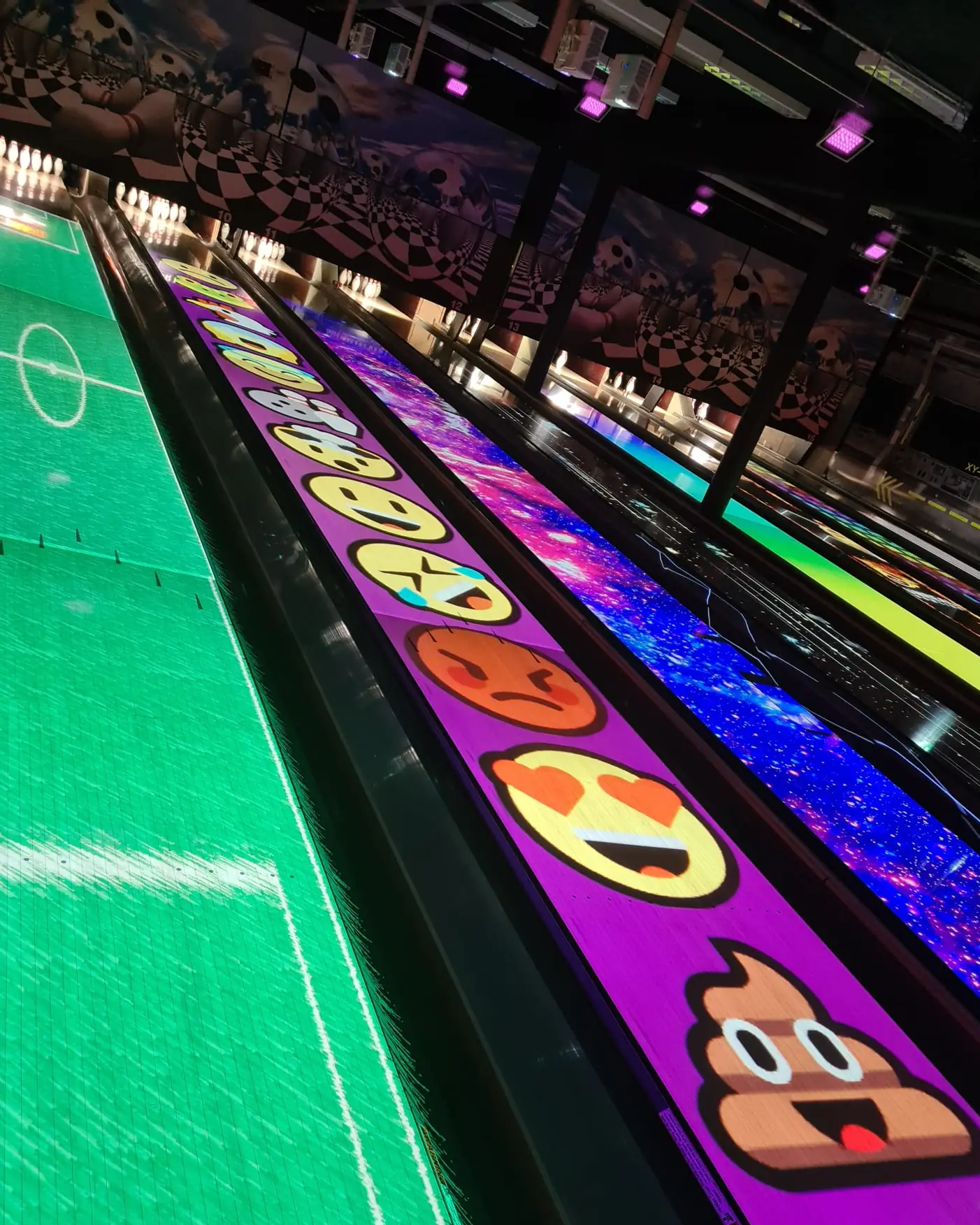 Bowlingbahnen mit grüner Fläche und Emoji-Projektion